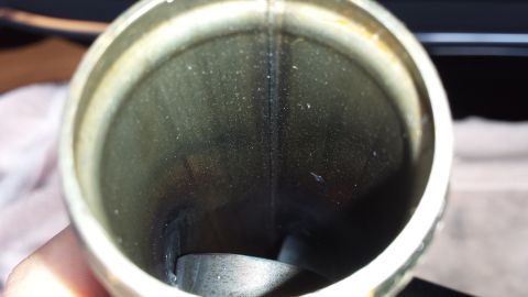 2005 Mercury Grand Marquis - Close-up view inside a metal pipe, possibly an exhaust component, showing wear and soot buildup.