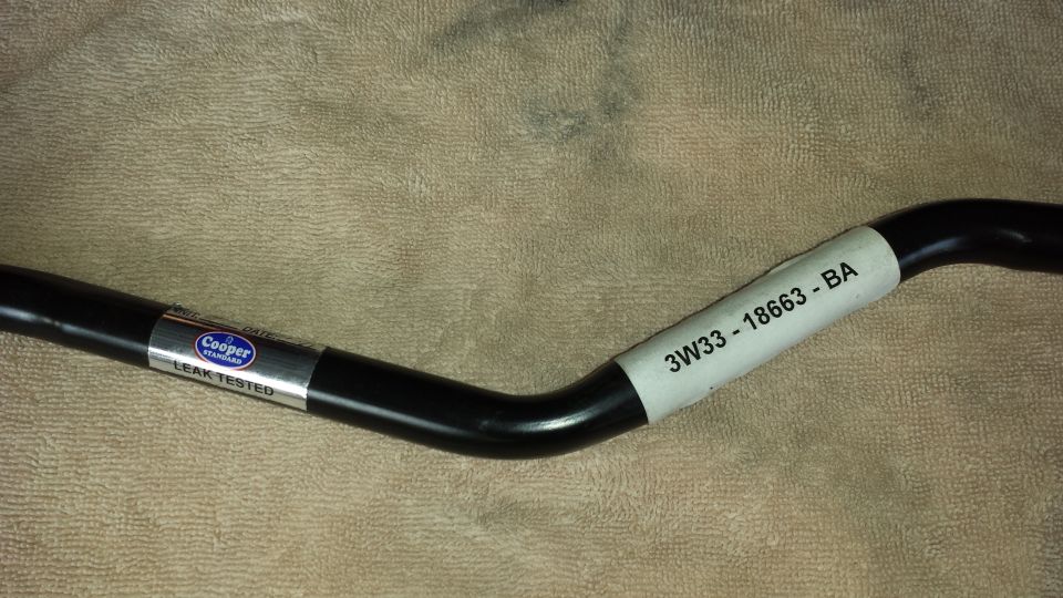 Black automotive part with labels 'Cooper Standard' and '3W33-18663-BA'