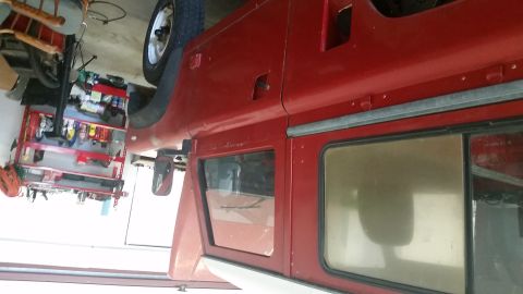 1984 Land Rover Defender - Side view of a red SUV, possibly a 1984 model.