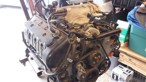 2005 Mercury Grand Marquis - A V8 engine is mounted on a stand, with various hoses and belts visible.