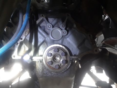1996 Ford F-350 - Close-up view of an engine block, flywheel, and associated components, likely during a repair or modification.
