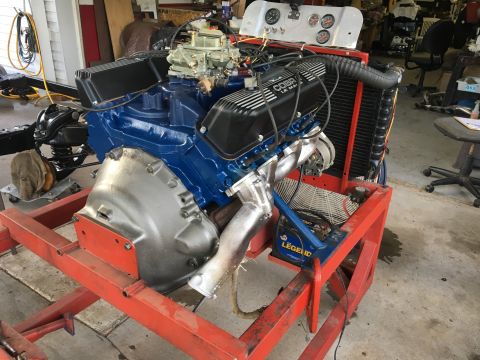 1969 Ford Mustang - A V8 engine with Cobra Le Mans valve covers is mounted on a stand for display or testing.