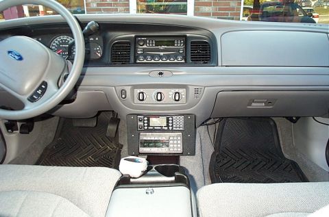 2001 Ford Crown Victoria - The interior of a 2001 Ford Crown Victoria shows a dashboard with aftermarket radio equipment and a center console.