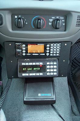2001 Ford Crown Victoria - The vehicle's interior features a console with installed Uniden and Motorola radio communication equipment.