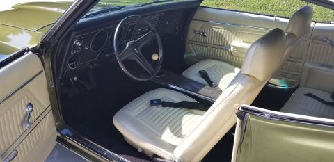1969 Pontiac Firebird - Interior view of a classic car, showing the dashboard, steering wheel, and front seats.