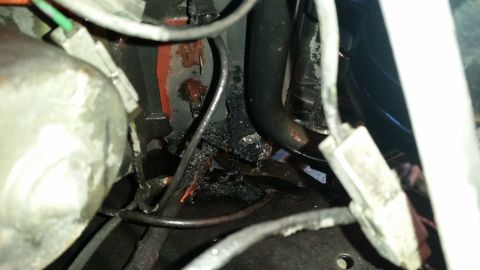 1985 Ford Bronco - This image shows significant damage to wiring and other engine components, likely from heat or fire.