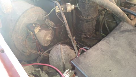 1985 Ford Bronco - Close-up view of engine bay components, including a blower motor and various hoses and wires.