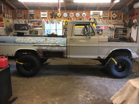 1967 Ford F-250 - A 1967 Ford F-250 pickup truck is shown in a garage, appearing to be in the process of restoration with visible bodywork.