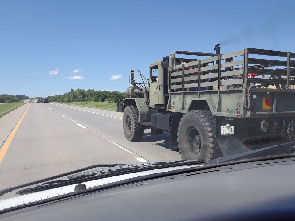 Military truck with wooden bed, seen from rear
