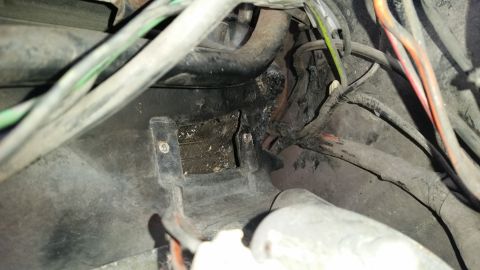1985 Ford Bronco - Wiring harness and mounting bracket in a vehicle's engine bay or dashboard area.