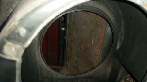 1985 Ford Bronco - Close-up view of a vehicle's headlight housing interior, showing signs of rust.