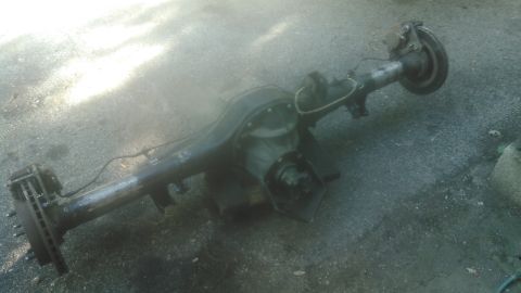 1978 Ford Bronco - A rear axle assembly, likely from a truck or SUV, is shown resting on the ground.