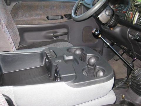 1968 Ford Mustang - The interior of a truck is shown, focusing on the center console and floor-mounted shifter.