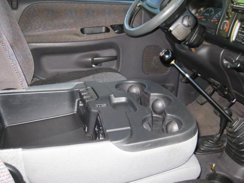 Interior view of a truck's center console and floor shifter