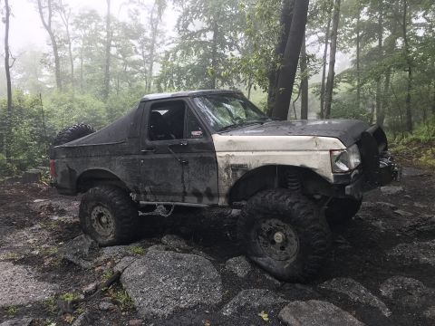 1989 Ford Bronco - This 1989 Ford Bronco navigates a challenging off-road course with large tires and a lifted suspension.