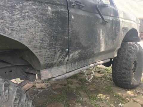 1989 Ford Bronco - This heavily mud-splattered SUV features prominent rock sliders and aggressive off-road tires, suggesting it's built for terrain.