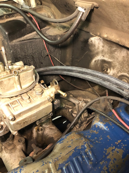 1981 Ford Bronco - Engine bay detail showing a carburetor and associated plumbing.