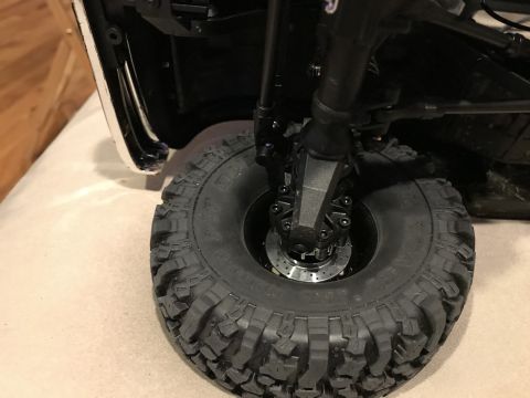 1989 Ford Bronco - Detail of an off-road tire and suspension system, likely from a model vehicle.