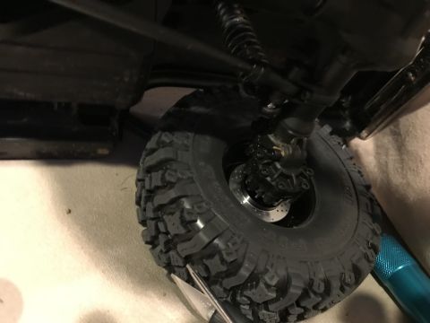 1989 Ford Bronco - The detailed suspension and tire of a remote-controlled vehicle are shown in this close-up shot.