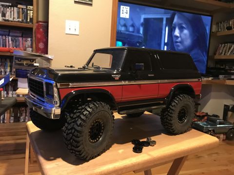 1989 Ford Bronco - RC model Bronco sits on a table, with a TV playing in the background.