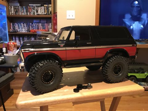 1989 Ford Bronco - A remote-controlled model of a classic Ford Bronco sits on a wooden table, with spare parts nearby.