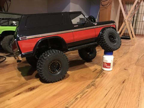 1989 Ford Bronco - Toy Ford Bronco, likely from the late 1970s, is propped up on a bottle.