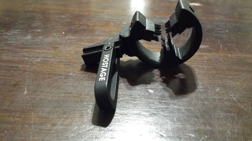 Black archery arrow rest with 'HOSTAGE' text visible