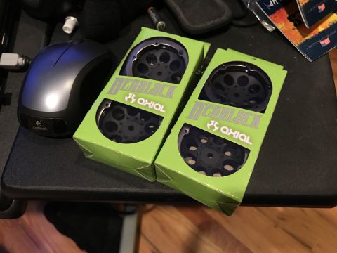 1989 Ford Bronco - Two new Axial Deadlock wheel sets are ready for installation on an RC vehicle.