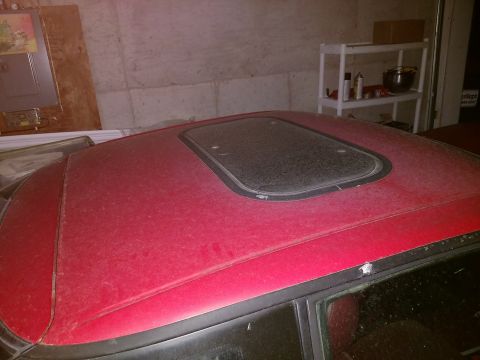 1989 Ford Probe — Dusty red car roof with a sunroof, close-up view