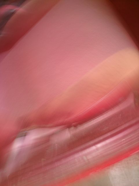 1989 Ford Probe — Abstract close-up of pink and red textured surface with motion blur.