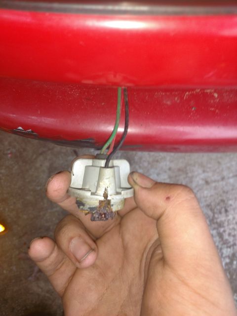1989 Ford Probe — Burnt-out car light bulb socket with wires attached to red car body