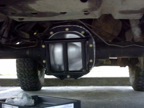 1995 Ford Bronco - The rear differential cover has been replaced. A drain pan sits below, ready for fluid.