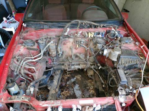 1989 Ford Probe engine bay with wiring and engine parts