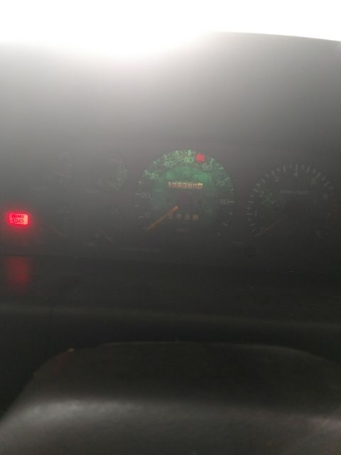 1989 Ford Probe - The image shows a close-up of a car's dashboard, focusing on the speedometer and odometer which reads 175397 miles. A red brake warning lig…