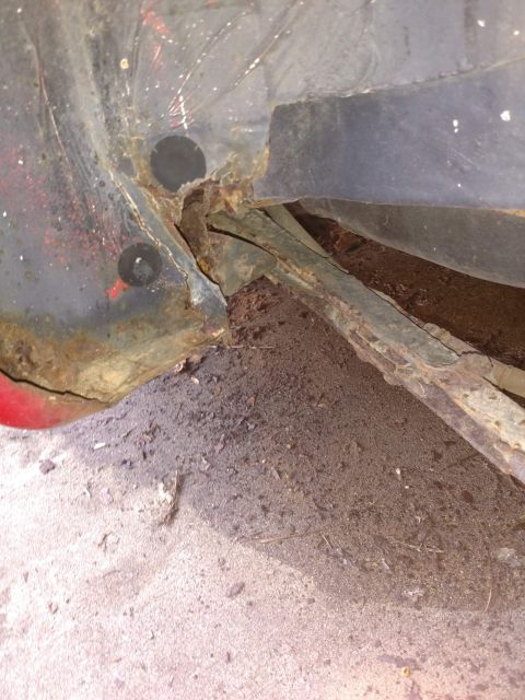 1989 Ford Probe - The image shows severe rust and damage to the undercarriage of a vehicle, with exposed metal and structural components visible. The area ap…