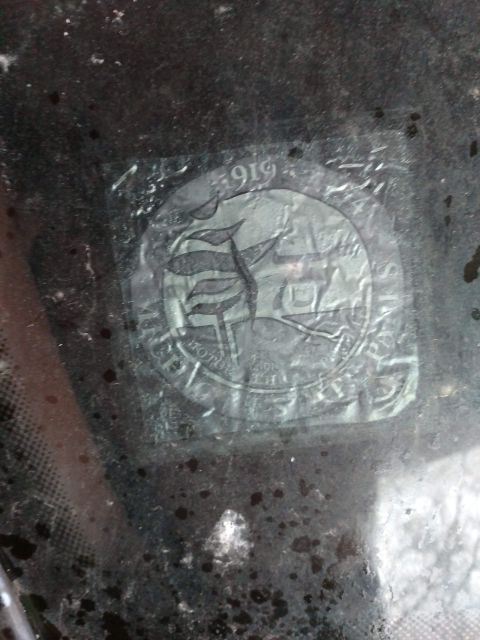 1989 Ford Probe - A close-up of a sticker on a vehicle windshield shows the year "1919" and a circular emblem with text that appears to read "MOTOR CLUB".