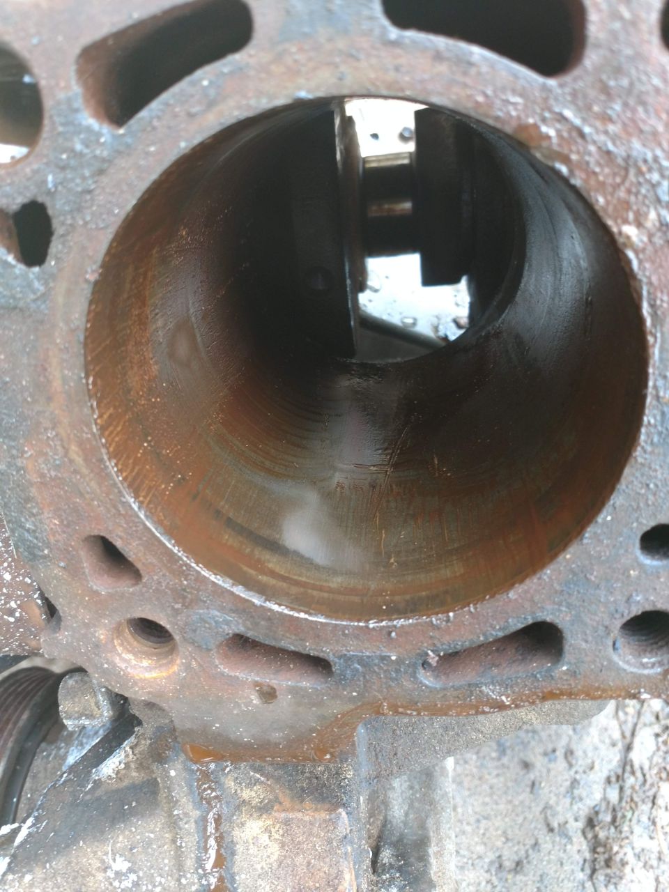 Close-up of a rusty engine cylinder bore with visible scoring.