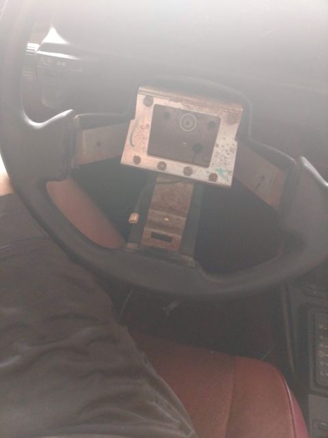 1989 Ford Probe - The image shows the steering column and part of the steering wheel of a car, with the steering wheel partially removed. The dashboard and p…