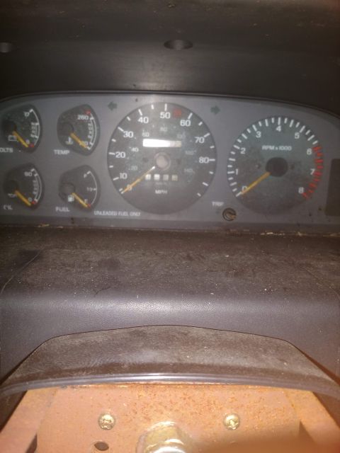 1989 Ford Probe - The image shows a close-up view of a car's dashboard, focusing on the instrument cluster. Visible gauges include speed, RPM, fuel level, te…