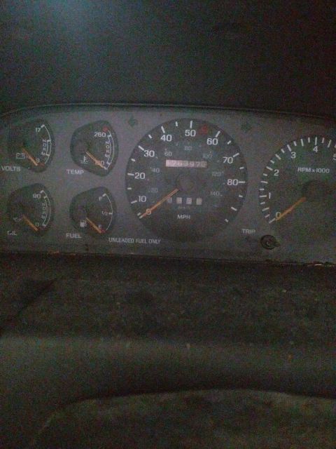 1989 Ford Probe - A close-up shot of a car's dashboard shows a speedometer, tachometer, fuel gauge, temperature gauge, and voltmeter. The odometer reads 7639…