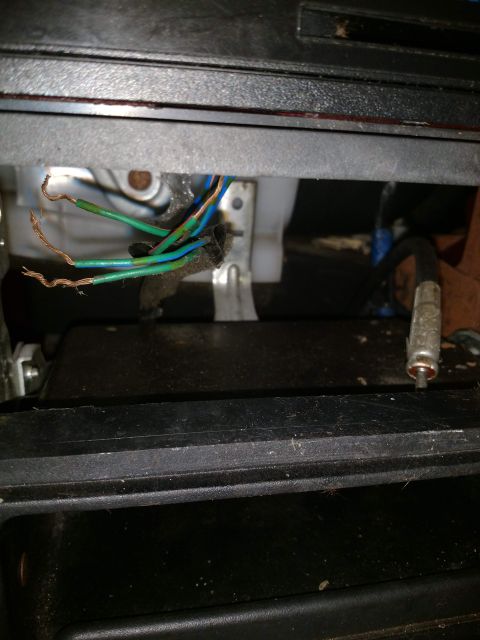 1989 Ford Probe - A close-up view shows several exposed wires with green and blue insulation, some with copper exposed, bundled together. A metal connector w…