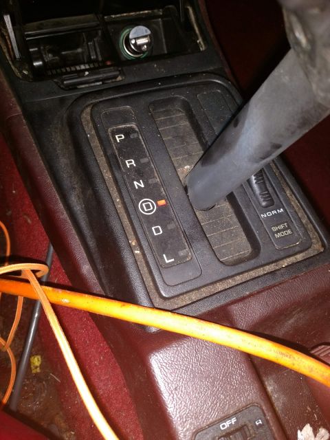 1989 Ford Probe - The image shows the interior of a car, focusing on the automatic gear shifter and console area. The gear selector is in the 'D' position, i…