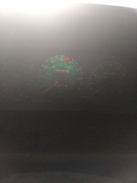 1989 Ford Probe - The image shows a close-up of a car's dashboard with a speedometer and tachometer visible. The speedometer reads 176397 miles.
