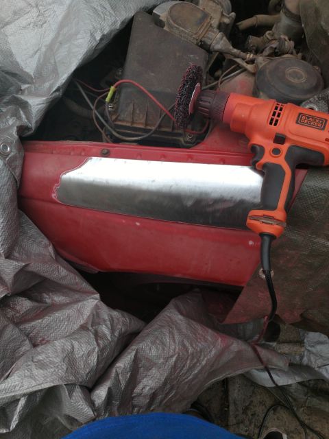1989 Ford Probe - A Black+Decker drill with a red abrasive wheel is shown attached to a metal panel on a red vehicle. The vehicle appears to be partially cov…