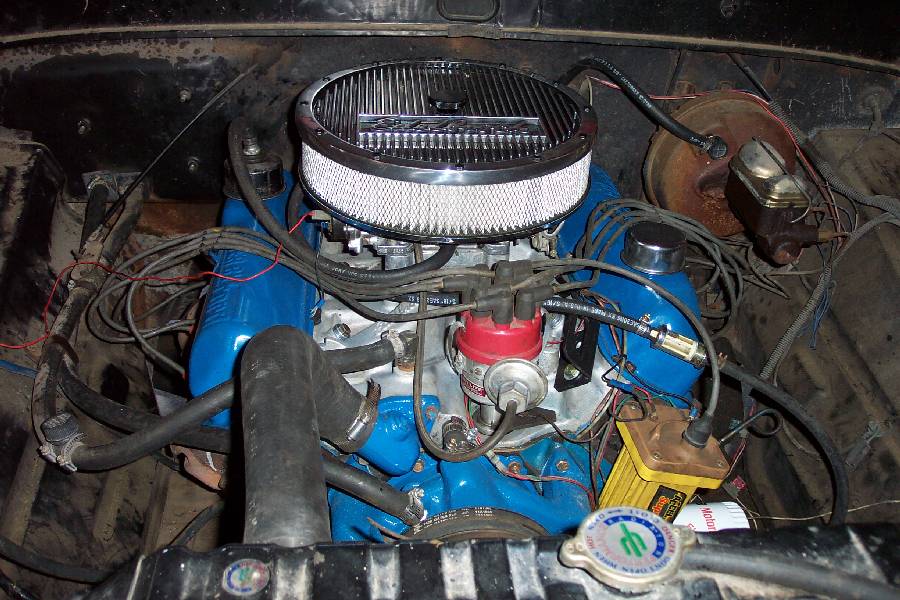 Blue Ford V8 engine bay with chrome Edelbrock air cleaner, red distributor cap and yellow coil