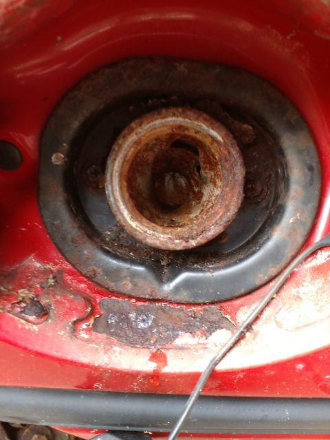 1989 Ford Probe - A detailed view of a vehicle's headlight housing, showing internal components and surrounding red bodywork.