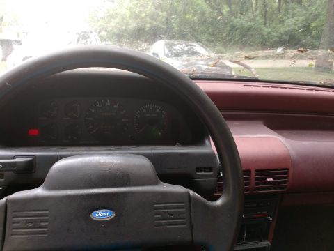 1989 Ford Probe - Interior view of a 1989 Ford Probe, with a second vehicle visible outside.