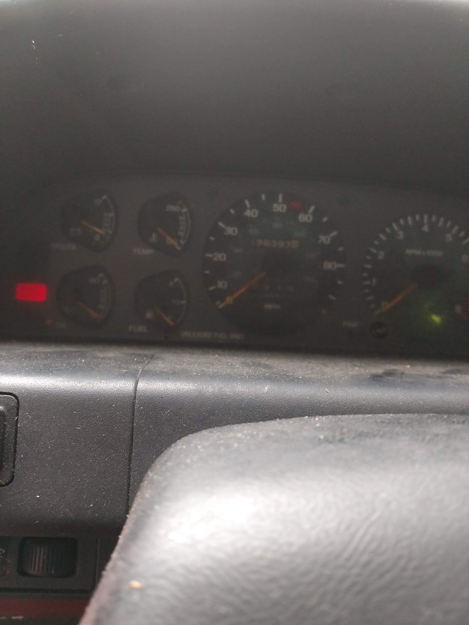Dashboard with speedometer, tachometer, fuel, temp, and oil gauges. Odometer reads 76337