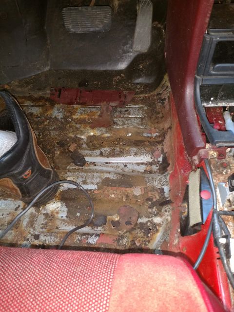 1989 Ford Probe - The floor of this vehicle's interior is severely rusted and appears to be in a state of disrepair.