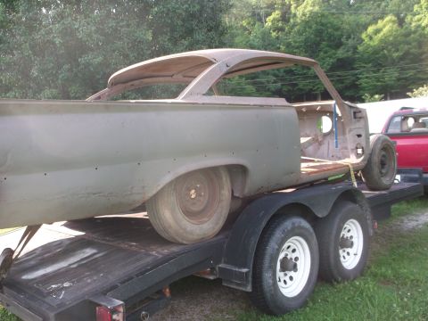 1961 Ford Starliner - A weathered car body, likely from the early 1960s, is transported on a trailer.